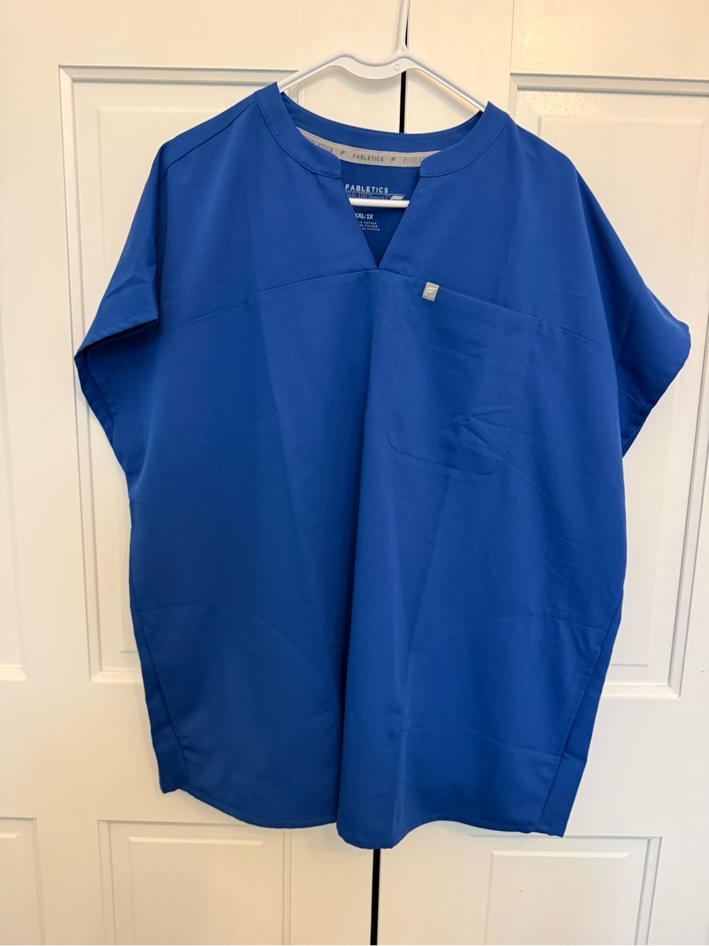 Fabletics Navy Blue V-Neck Scrub Top with Gold Logo Tab